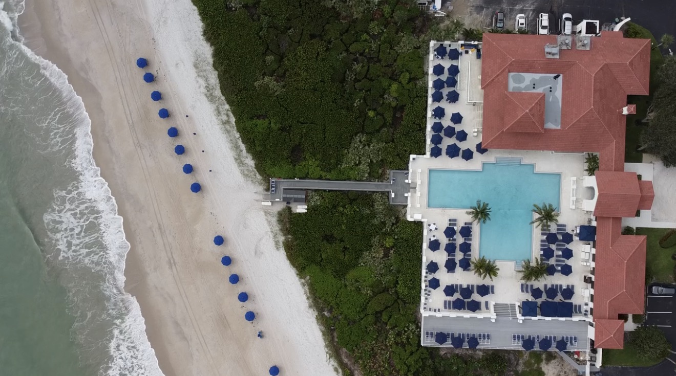 Aerial view of the pool and private beach at Grand Harbor Beach Club