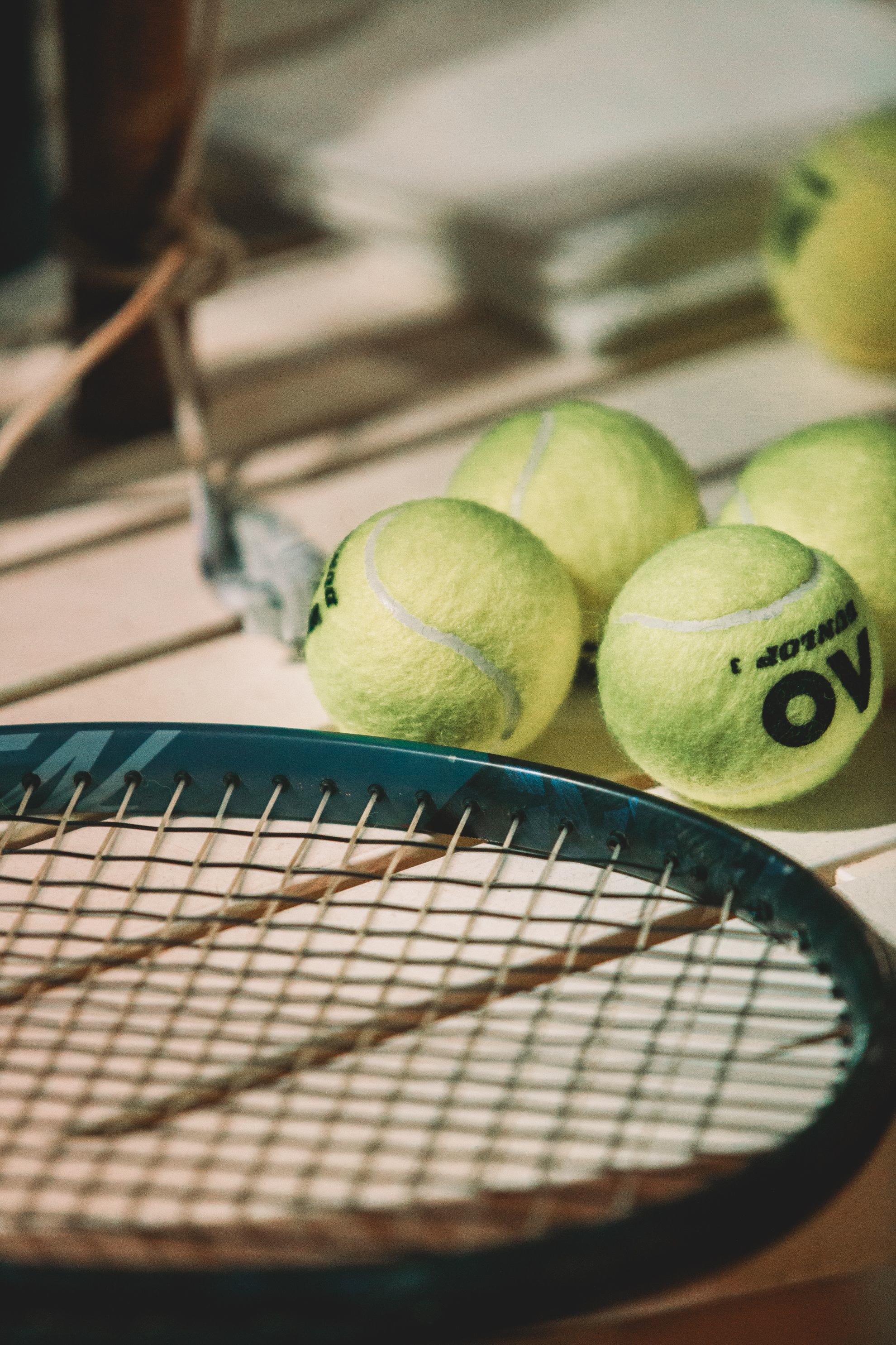 Close-up of a tennis racket and balls, evocative of John's Island's tennis facilities